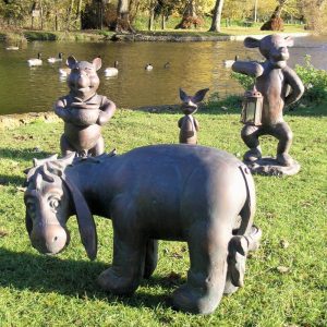 Winnie the pooh garden statues in the garden featuring Eeyore in the foreground then Winnie the Pooh, Piglet and Tigger behind
