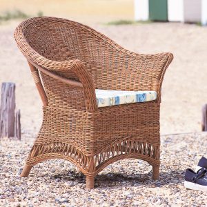 lloyd loom chair with a seat pad on