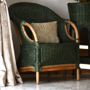 olive natural cane tub chair in an indoor setting