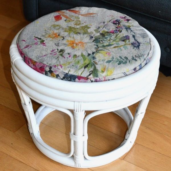 White wicker footstall with cushion